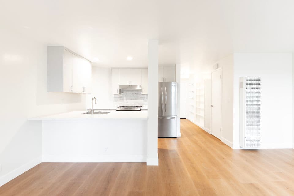Renovated kitchen with custom cabinetry and stone counters