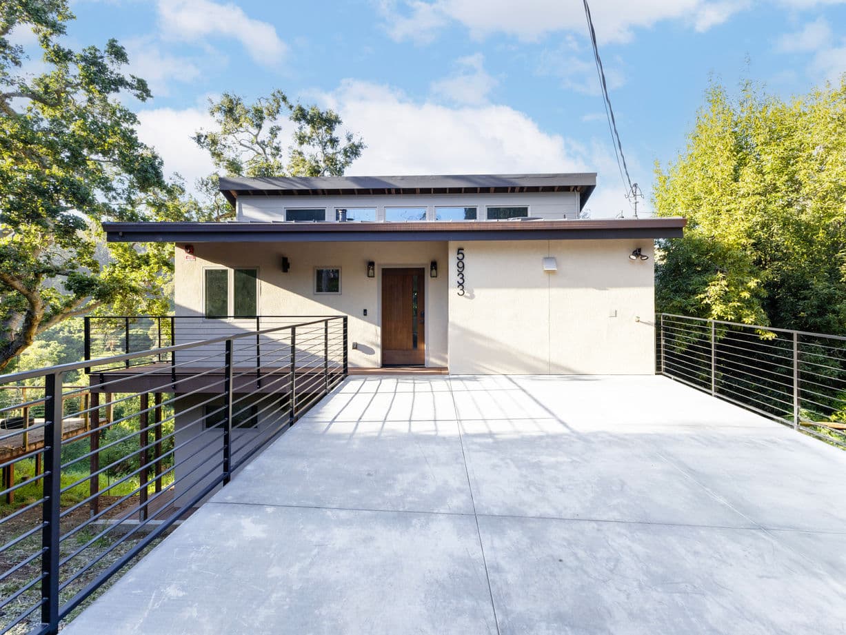 Outdoor patio and landscaped yard completed alongside a home addition